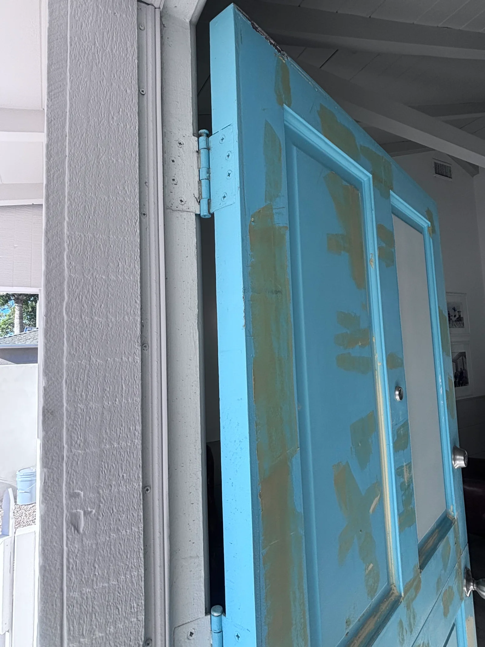 Turquoise painted interior double doors with glass panels and blue hinges