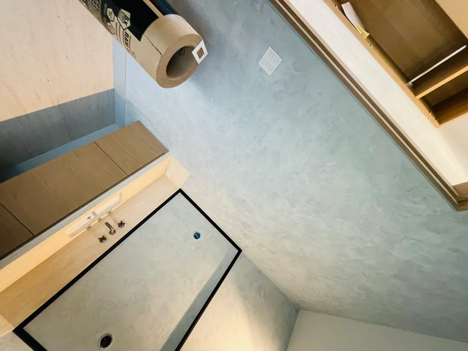 Bathroom with finished drywall, taped joints, and light blue-gray paint on walls and ceiling