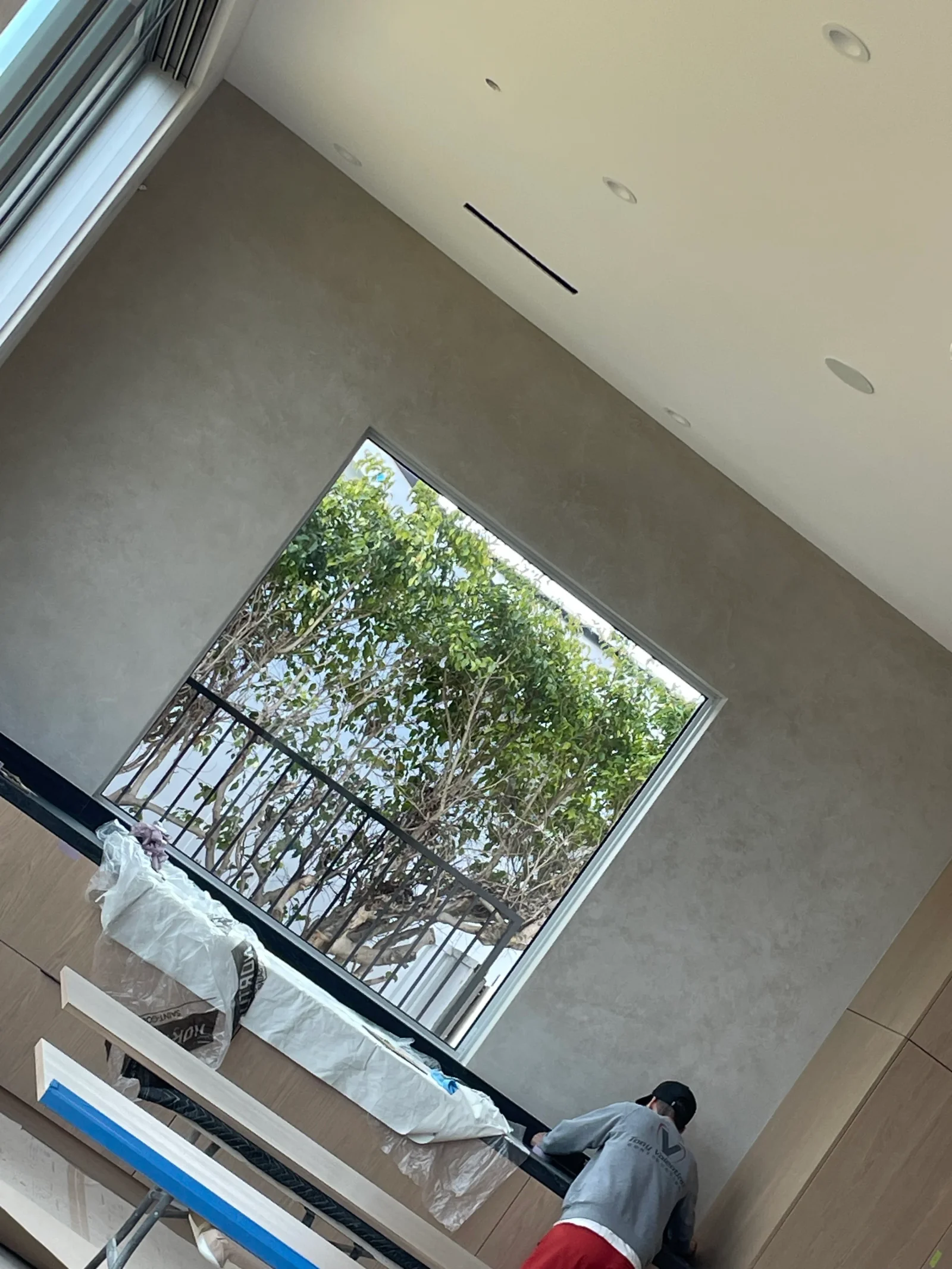 Interior drywall finishing with recessed lights and window frame installation